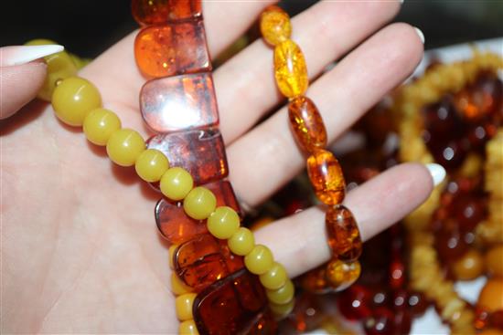 A quantity of amber and faux amber bead necklaces.